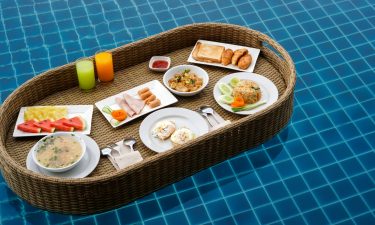 A floating breakfast is seen in a pool.