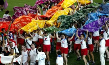 Participants from the United Kingdom team march onto the field during the opening ceremony of the 2002 Gay Games in Sydney