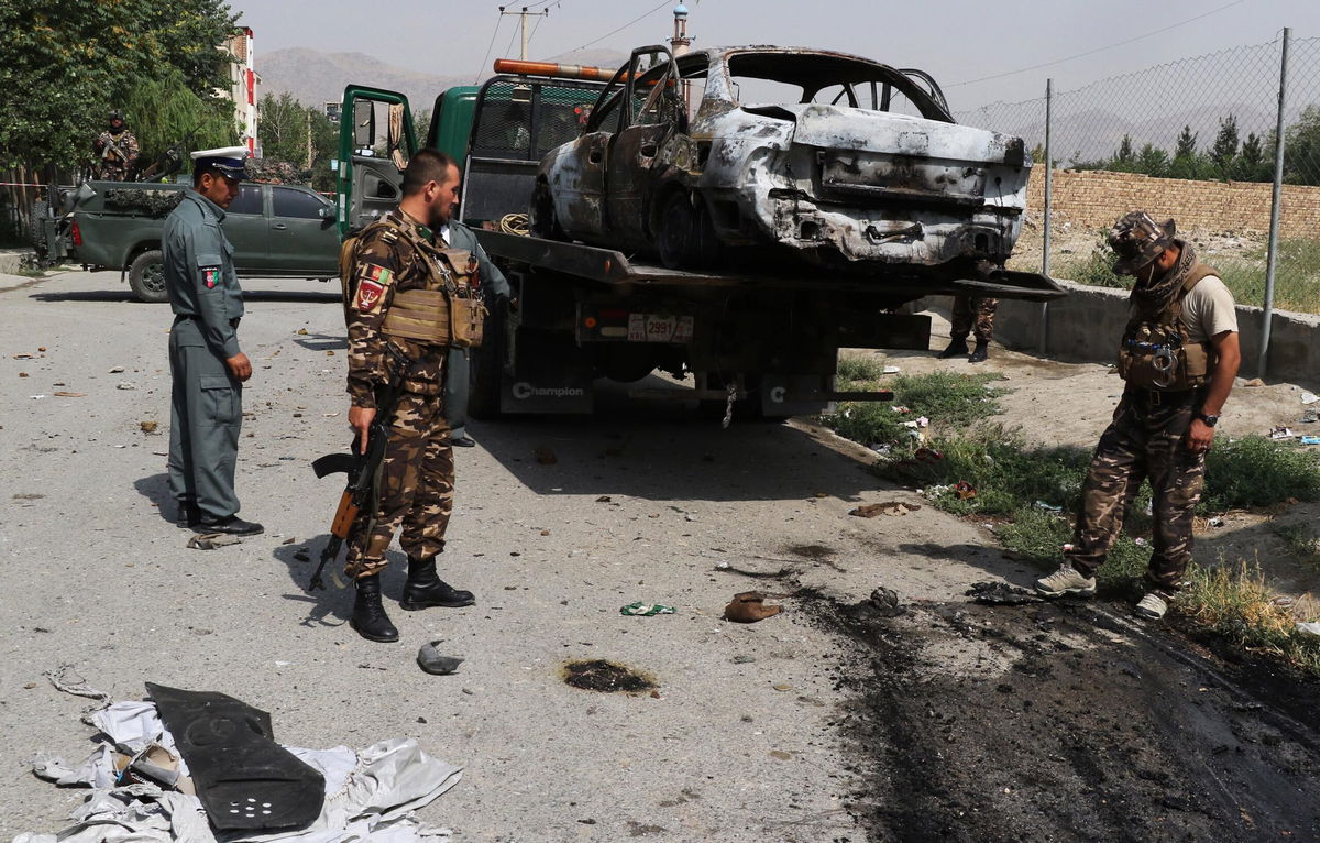 <i>Haroon Sabawoon/Anadolu Agency/Getty Images</i><br/>Afghan security forces inspect the scene after rockets were launched near the presidential palace in Kabul