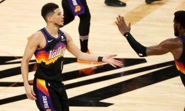 Devin Booker #1 of the Phoenix Suns is congratulated by teammates while coming to the bench for a time out during the second half in Game Two of the NBA Finals against the Milwaukee Bucks at Phoenix Suns Arena on July 8 in Phoenix
