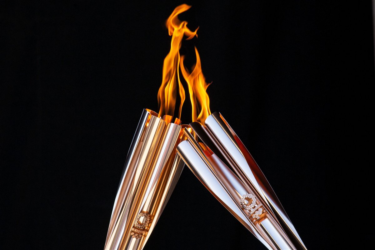 <i>Yuichi Yamazaki/Getty Images</i><br/>Torch bearers exchange the flame during the Olympic Torch Relay Celebration event on July 21