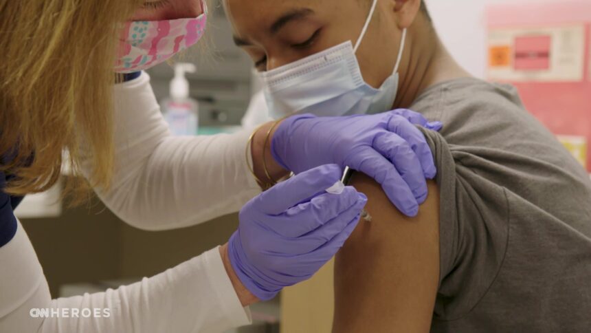 A patient receives the Covid-19 vaccine at office of CNN Hero Dr. Wendy Ross.