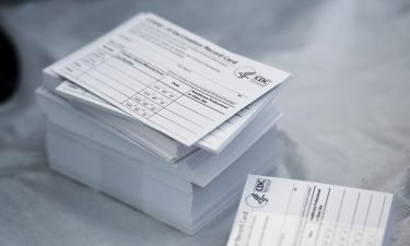 A stack of COVID-19 Vaccination Record Cards is pictured from the CDC. The commanding general of the Army base at Fort Rucker