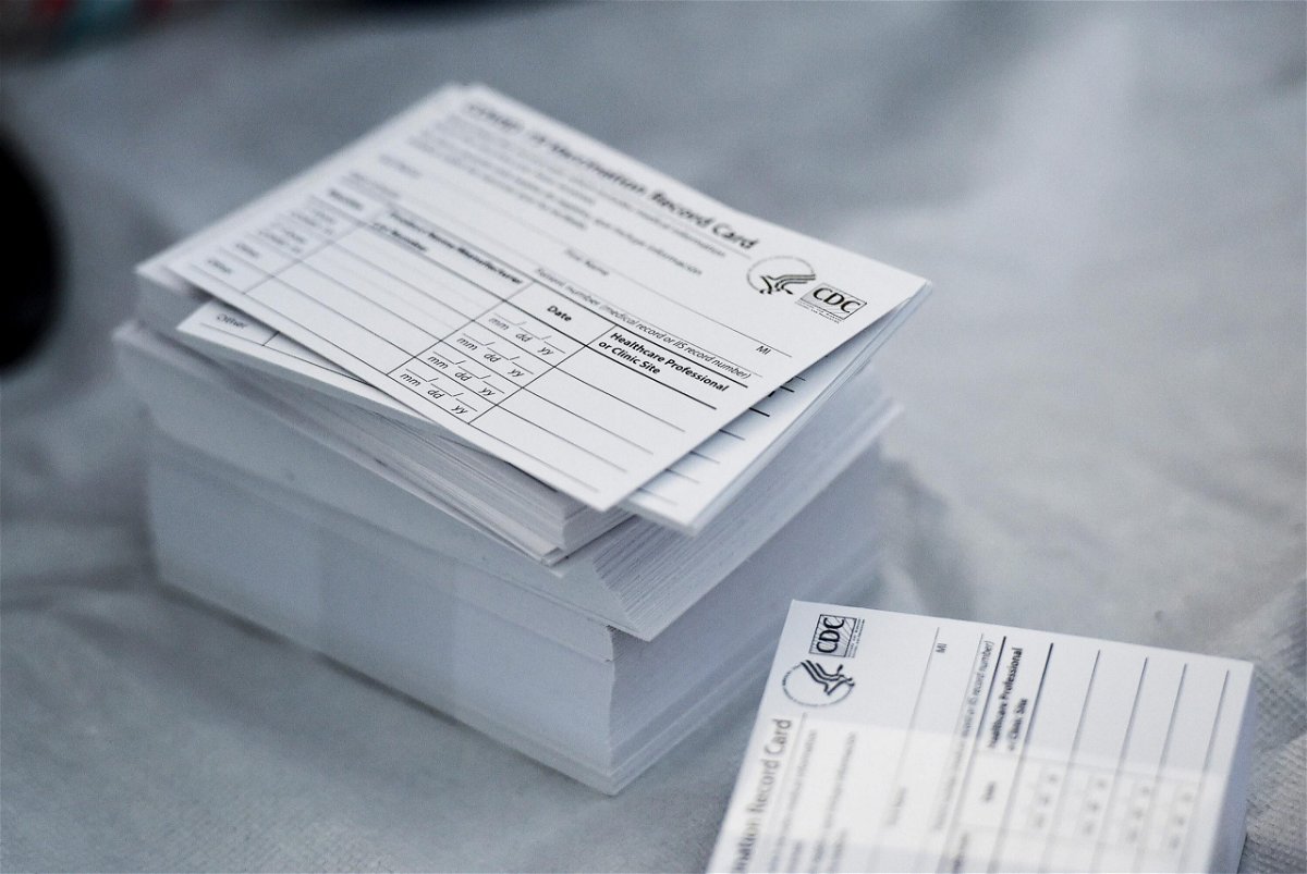 A stack of COVID-19 Vaccination Record Cards is pictured from the CDC. The commanding general of the Army base at Fort Rucker