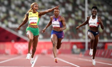 Elaine Thompson-Herah celebrates as she wins 100m gold at the Tokyo Olympics.