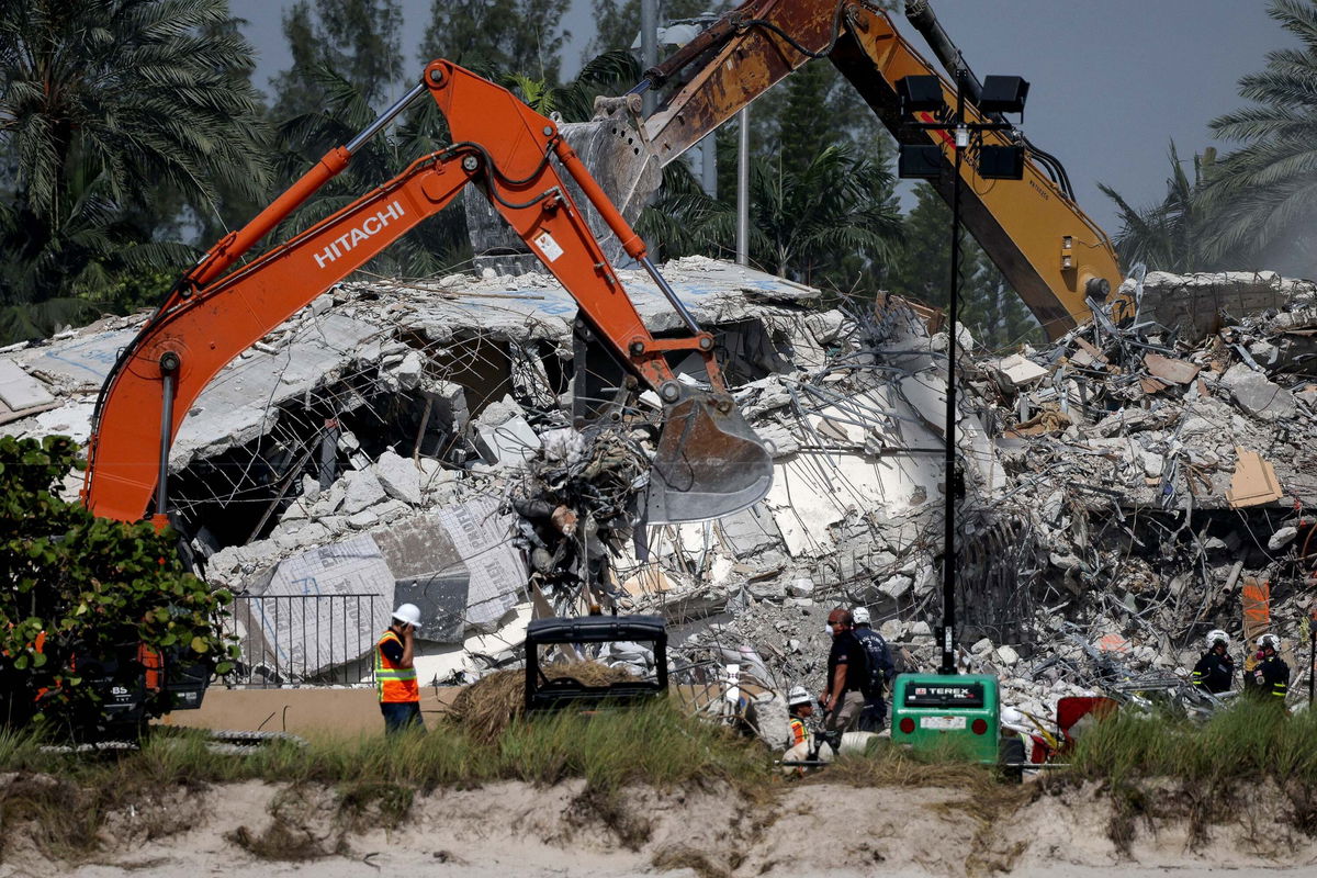 <i>Anna Moneymaker/Getty Images</i><br/>Excavators dig through the remains from the collapsed 12-story Champlain Towers South condo building on July 9 in Surfside