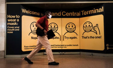 A person wears a mask while walking in Grand Central Terminal on July 27 in New York City.