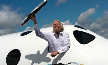 Richard Branson is attempting to become the first billionaire to travel to space. Branson poses for photographs in the window of a replica of the Virgin Galactic in Hampshire