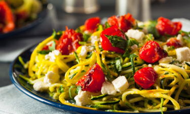 Zucchini noodle pasta is served here with tomatoes and feta.