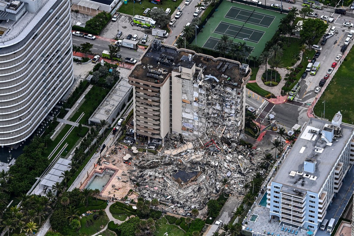 <i>Chandan Khanna/AFP/Getty Images</i><br/>Miami-Dade leaders announce a series of meetings for policy changes after the Surfside condo building collapse. Aerial image shows the collapsed building on June 24.