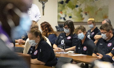 Father Don Ajoko prays Monday for blessings for nearly three dozen health care workers from around the country who arrived to help at Our Lady of the Lake Regional Medical Center in Baton Rouge