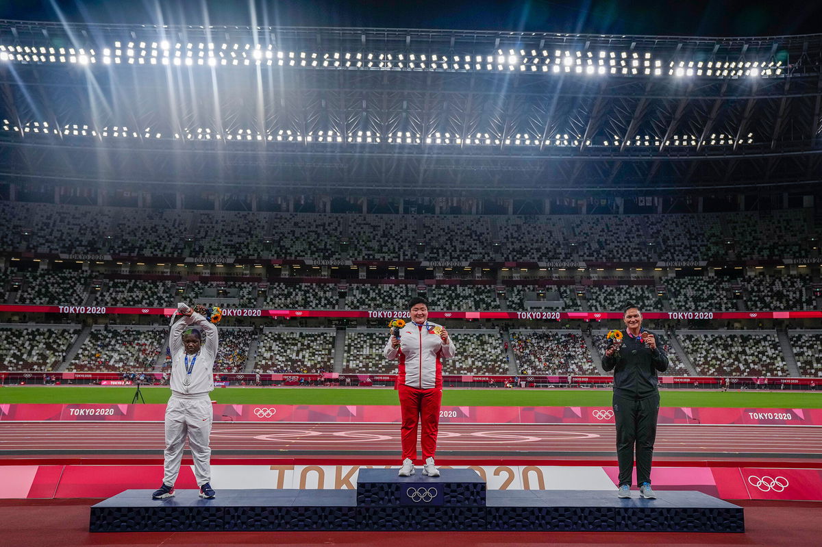 <i>Francisco Seco/AP</i><br/>Raven Saunders performing her X gesture on the shot put medal podium.