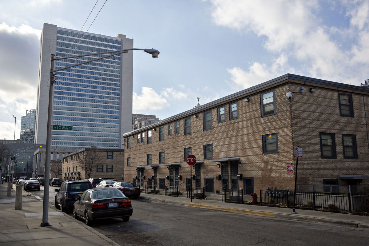 <i>Daniel Acker/Bloomberg/Getty Images</i><br/>The Cabrini-Green rowhouses stand in front of a residential tower in Chicago in 2018. Cook County