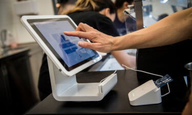 Square anounced Sunday that it's buying Afterpay for $29 billion. A customer uses a Square Inc. device to make a payment in San Francisco