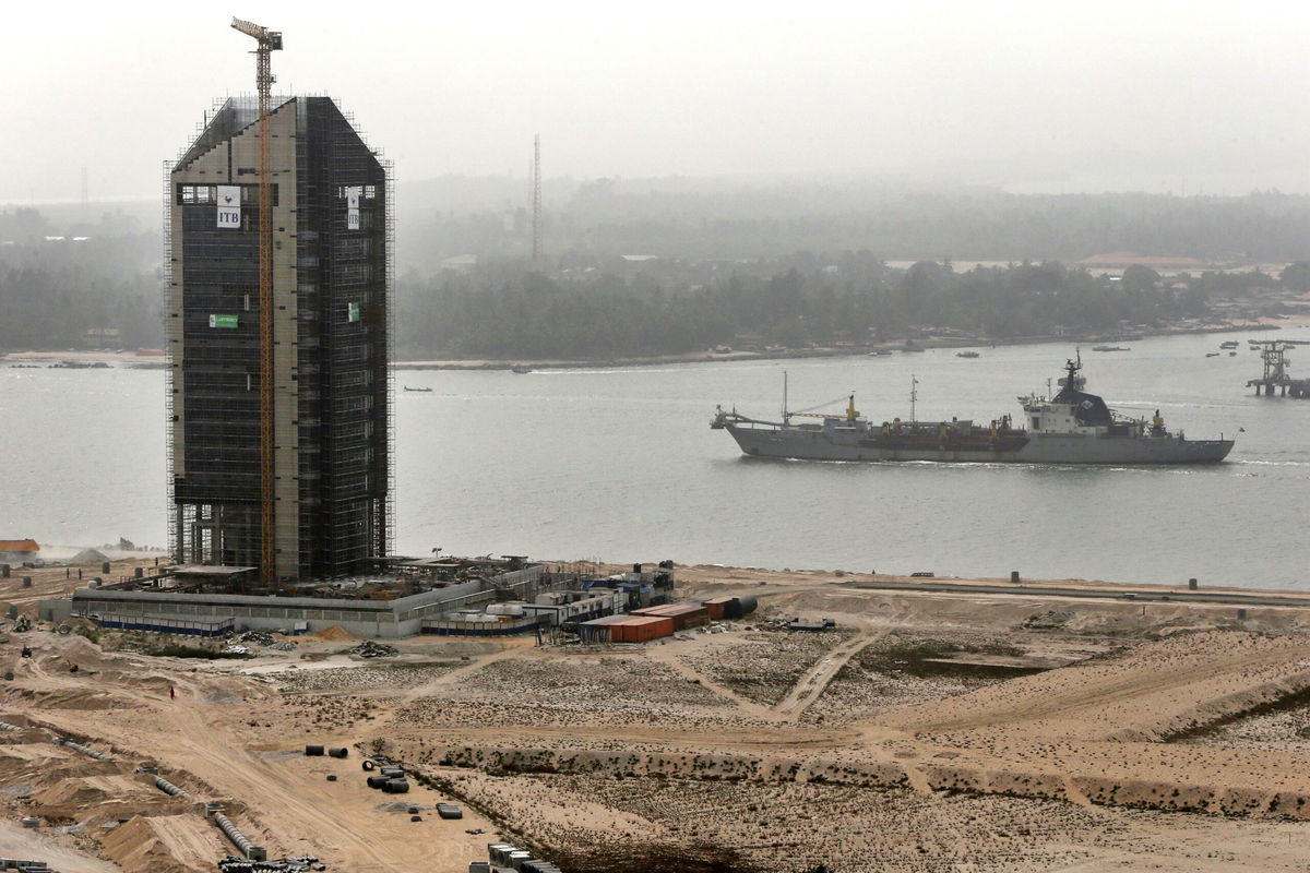 <i>George Osodi/Bloomberg/Getty Images</i><br/>A cargo ship passes along a waterway during construction at the Eko Atlantic city site in February 2016.