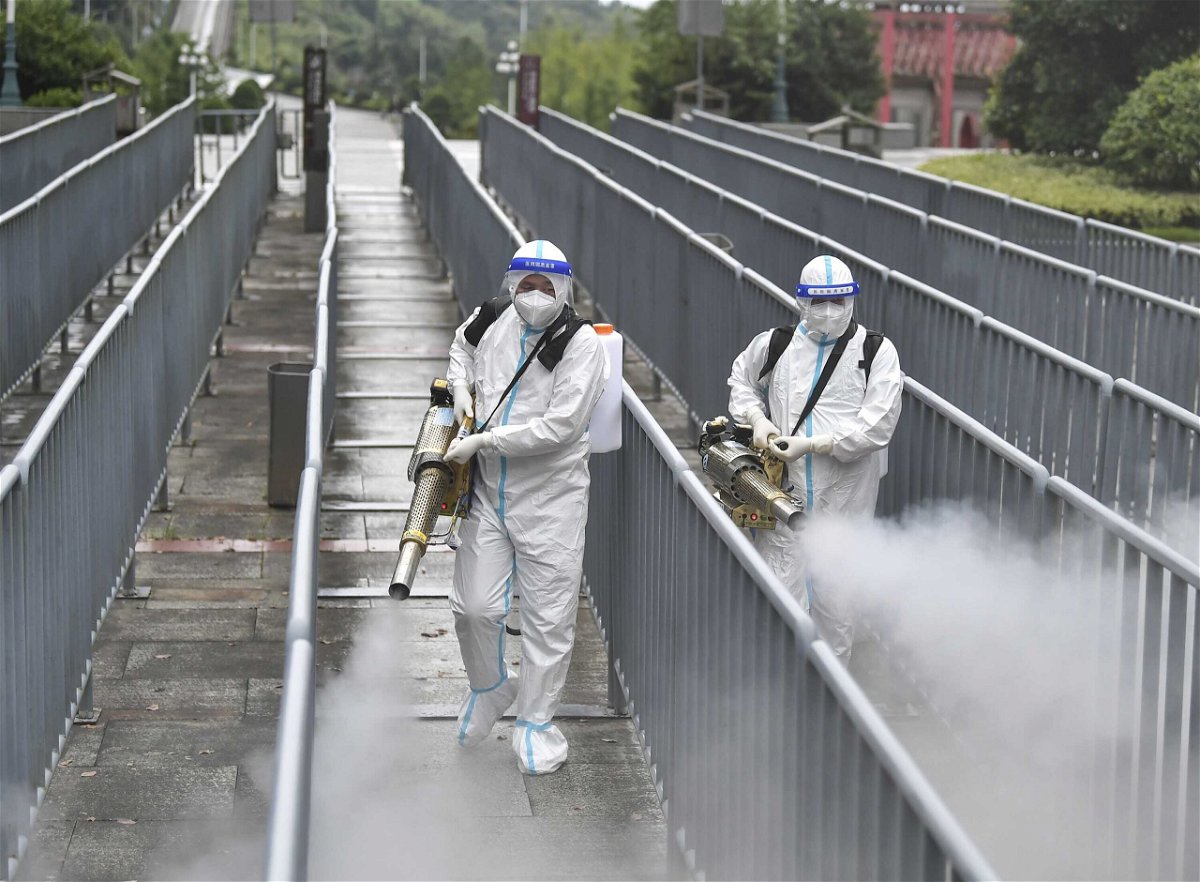 <i>Shao Ying/VCG/Getty Images</i><br/>China's economy stalled this month due to the Delta variant and ongoing shipping crisis. Workers spray disinfectant to halt the spread of Covid-19 on August 26