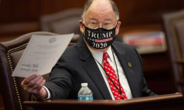 Republican Party of Florida National Committeeman Peter Feaman holds up the documents he and the rest of the 29 Florida Presidential Electors used to cast votes for Donald Trump and Mike Pence during a meeting of the electors at the Capitol in Tallahassee