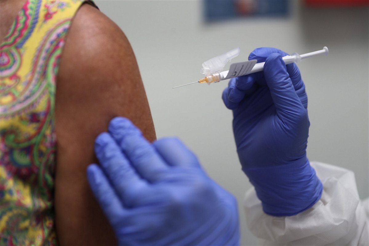 <i>Joe Raedle/Getty Images</i><br/>Black and Hispanic people miss out on Covid-19 testing and vaccinations. Pictured is a woman receiving the Covid-19 vaccine on August 07