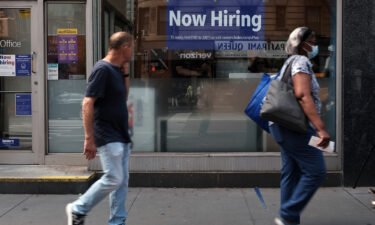 A hiring sign is displayed in a store window in Manhattan on August 19 in New York City. Only 235