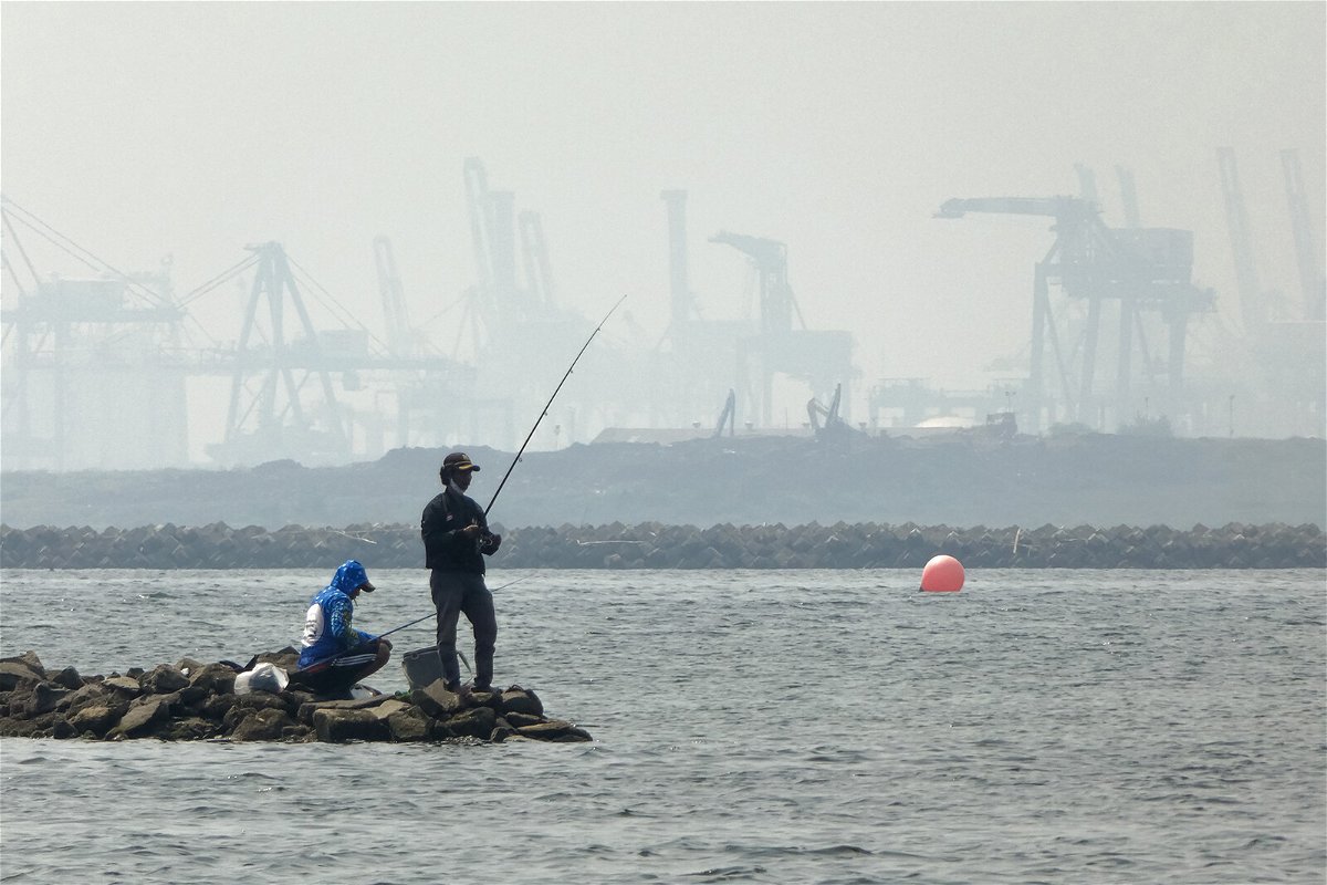 <i>Bay Ismoyo/AFP/Getty Images</i><br/>Anglers fish amid thick haze at a coastal area in Jakarta on June 20