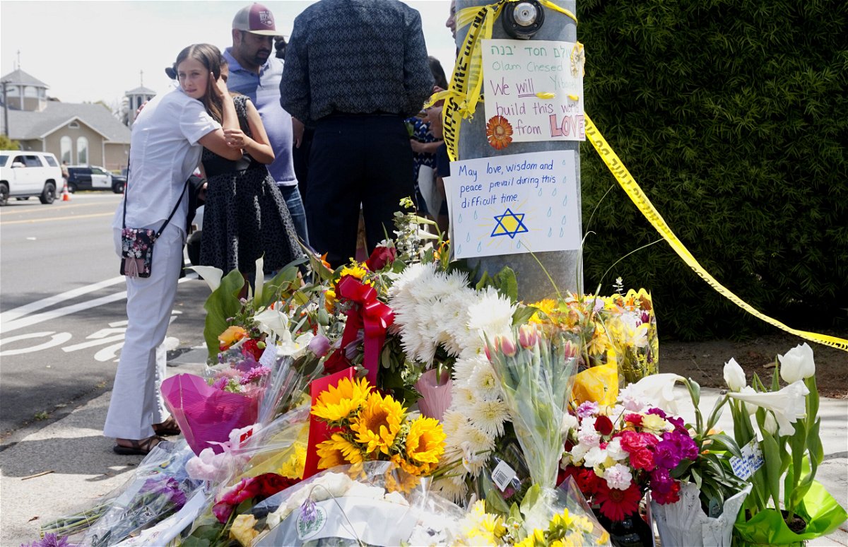 <i>Sandy Huffaker/AFP/Getty Images</i><br/>Mourners and well-wishers leave flowers and signs at a makeshift memorial across the street from the Chabad of Poway Synagogue on April 28