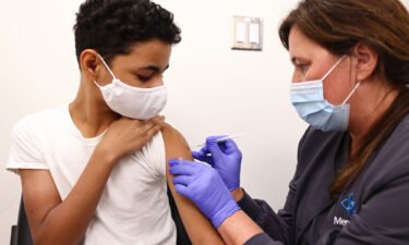 Clinical pharmacist Laura Gaar administers a COVID-19 vaccination dose to a 14-year-old at Lake Charles Memorial Hospital on August 10 in Lake Charles