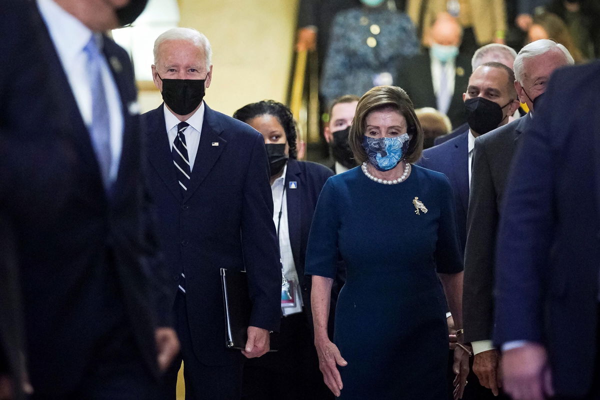 <i>Al Drago/Reuters</i><br/>U.S. President Joe Biden is escorted by House Speaker Nancy Pelosi (D-CA) as he arrives to speak with the House Democratic Caucus to provide an update on the Build Back Better agenda and the bipartisan infrastructure deal at the U.S. Capitol in Washington