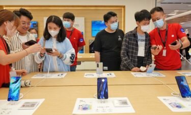 Xiaomi stumbled in the third quarter as it grappled with fallout from the global chip shortage and fiercer competition. Customers are shown here buying phones at a Xiaomi store in Yantai