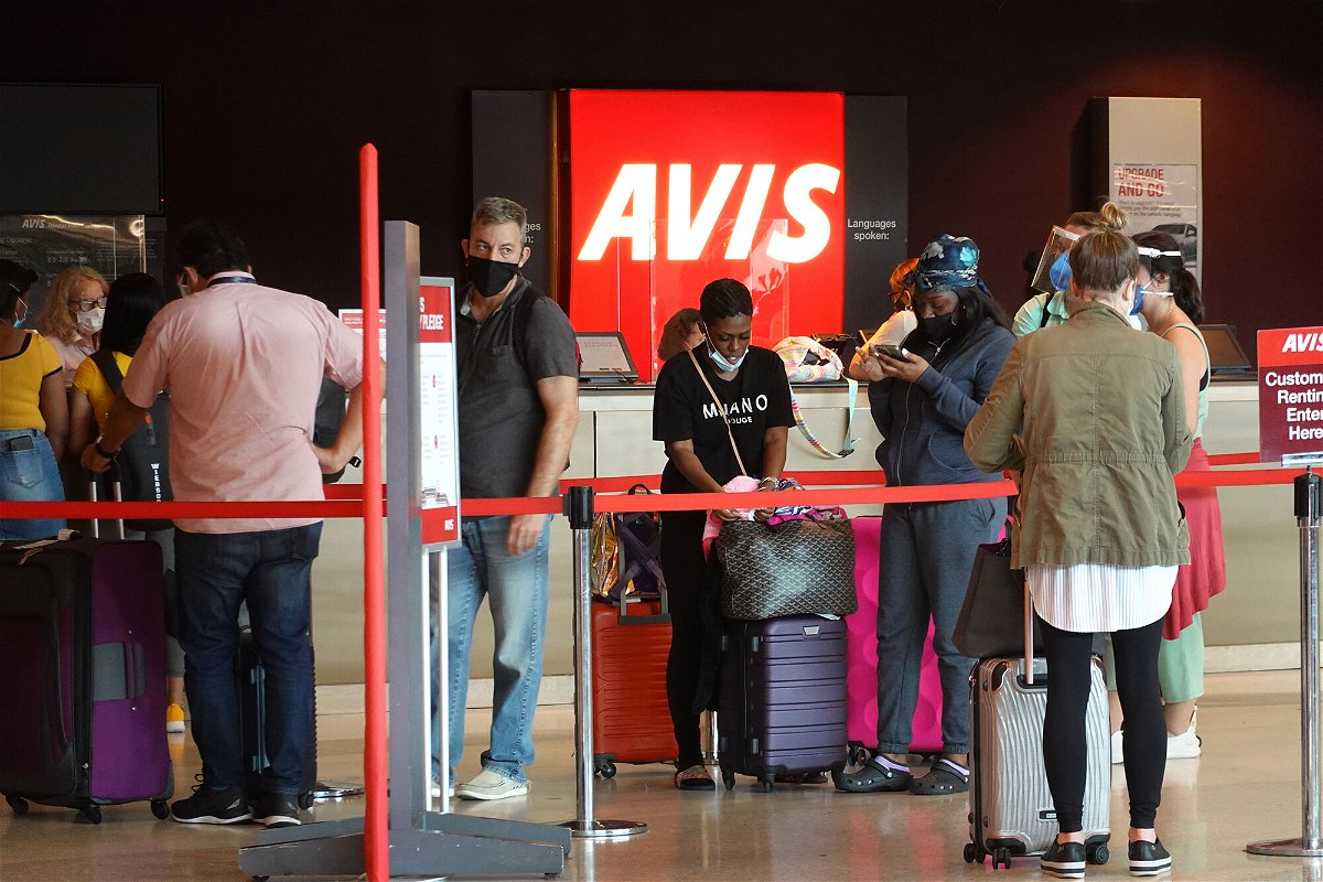 <i>Joe Raedle/Getty Images</i><br/>People wait in line at Avis rental agency in the Miami International Airport Car Rental Center on April 12