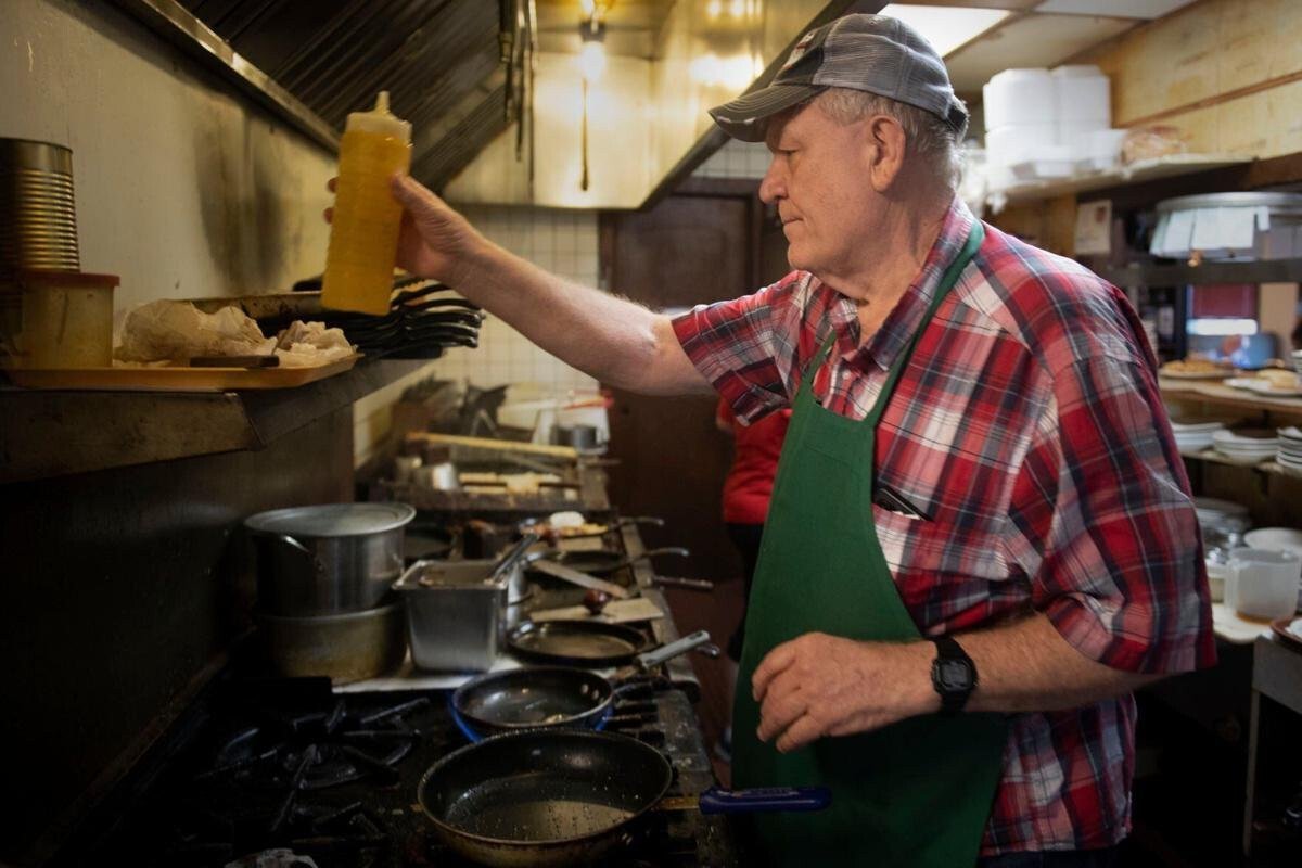 <i>Lincoln Journal Star</i><br/>Jim Wilkinson works in the kitchen at HoneyCreek Dining on Thursday.