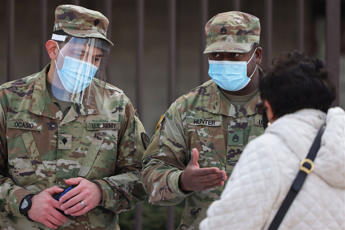 <i>Michael M. Santiago/Getty Images</i><br/>National Guard soldiers help people sign up for their vaccination appointments on February 24