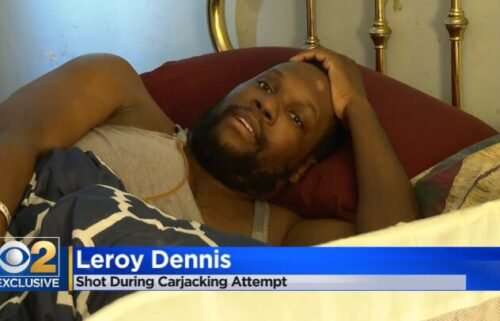 Leroy Dennis lay in bed in his Chicago home. Dennis is recovering after he was shot on the way to work by someone trying to take his car.