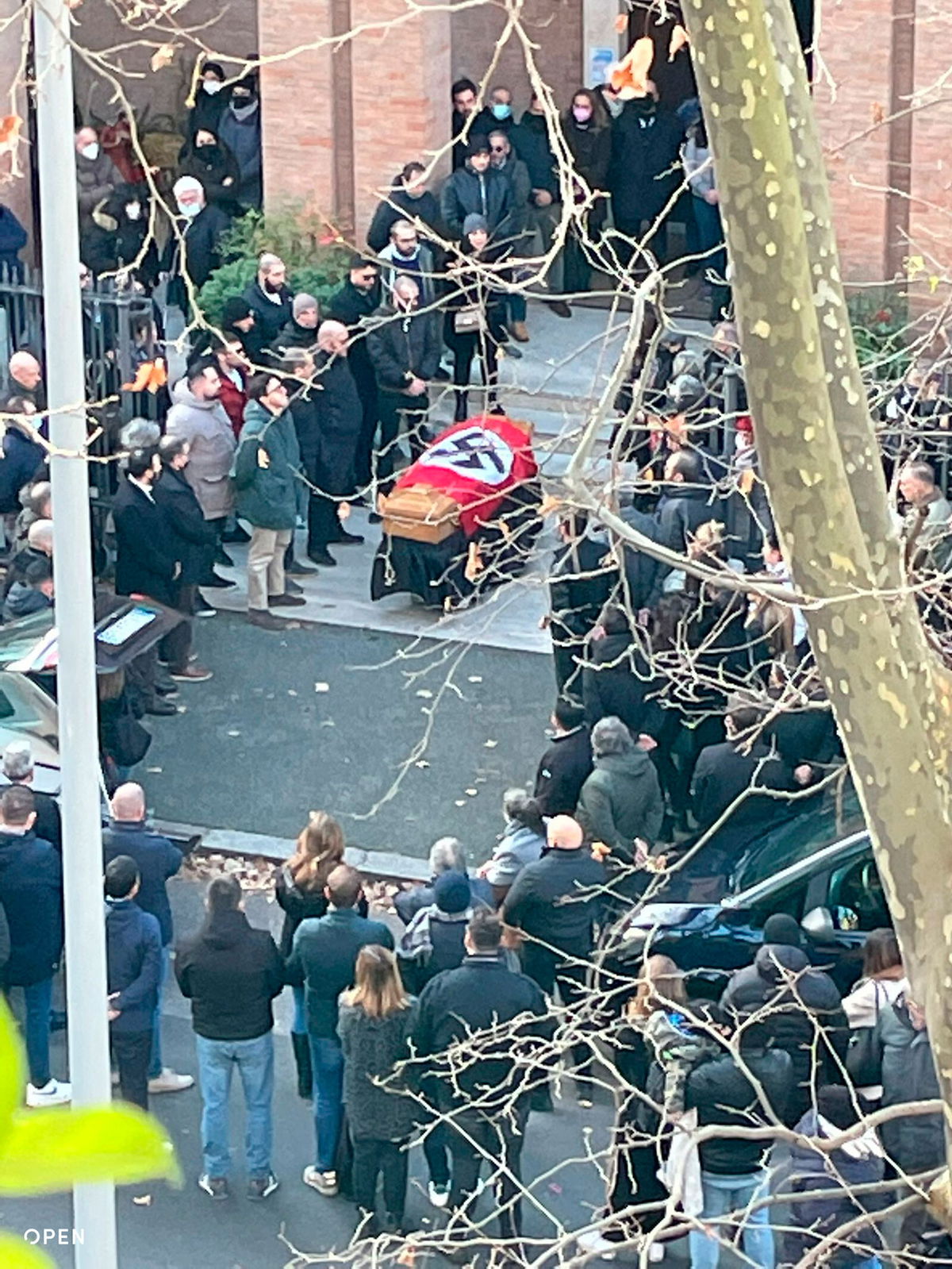 <i>Open Via AP</i><br/>People gathered around a swastika-covered casket outside the St. Lucia church in Rome