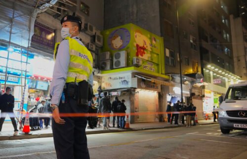 A police officer stands guard outside a pet store that was closed after some pet hamsters tested positive for Covid-19 in Hong Kong on January 18.