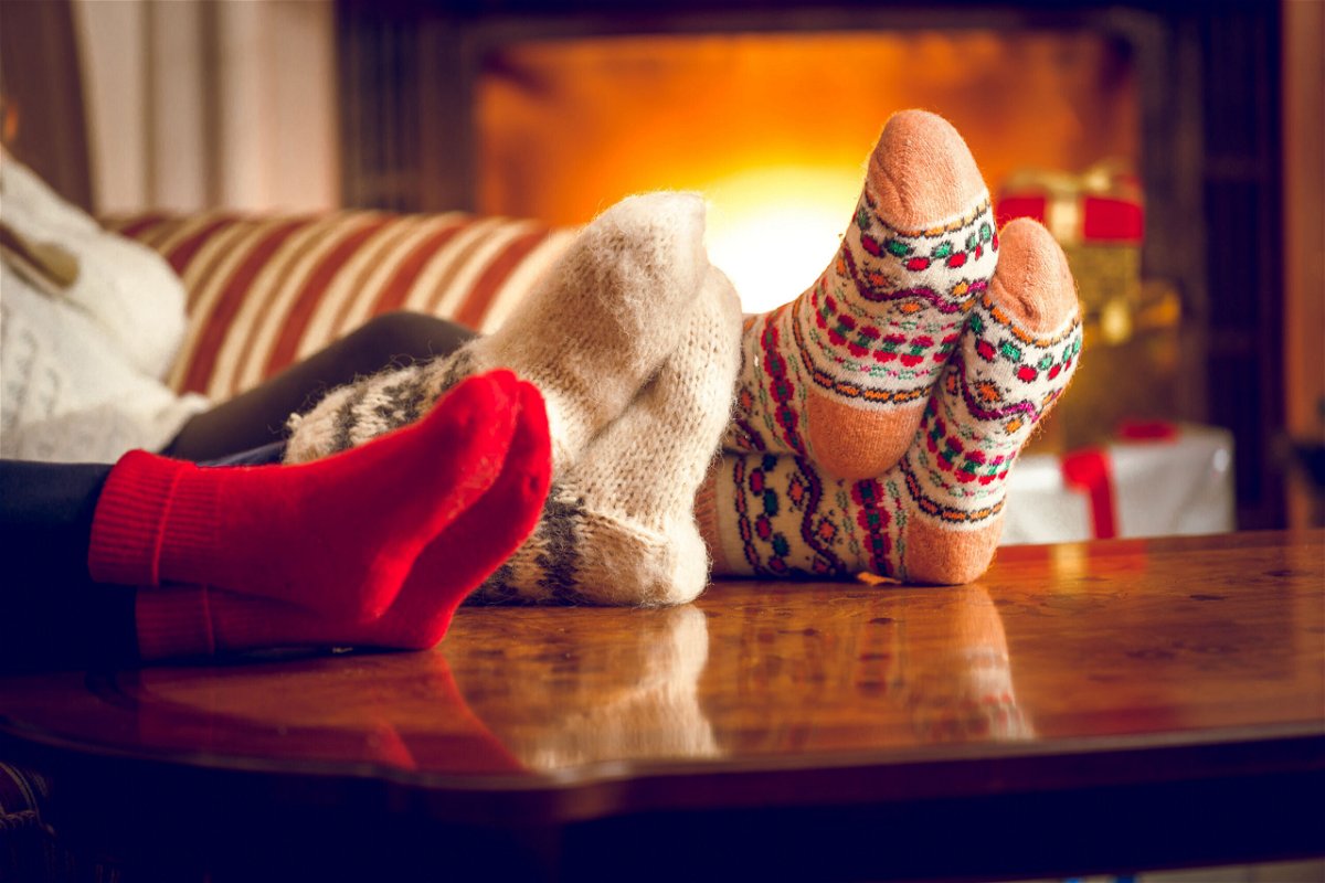 <i>Shutterstock</i><br/>Cozying up underneath layers of clothing or blankets (or both) can help insulate you from the cold.