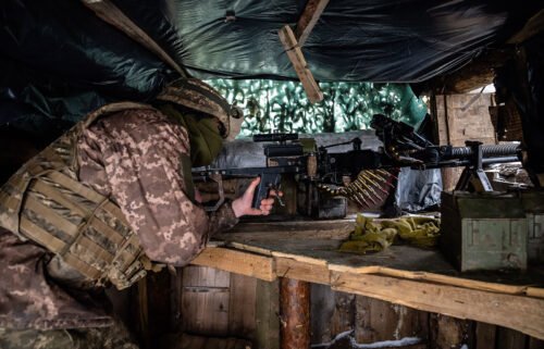 A Ukrainian soldier at a gunner position in a trench on the front line