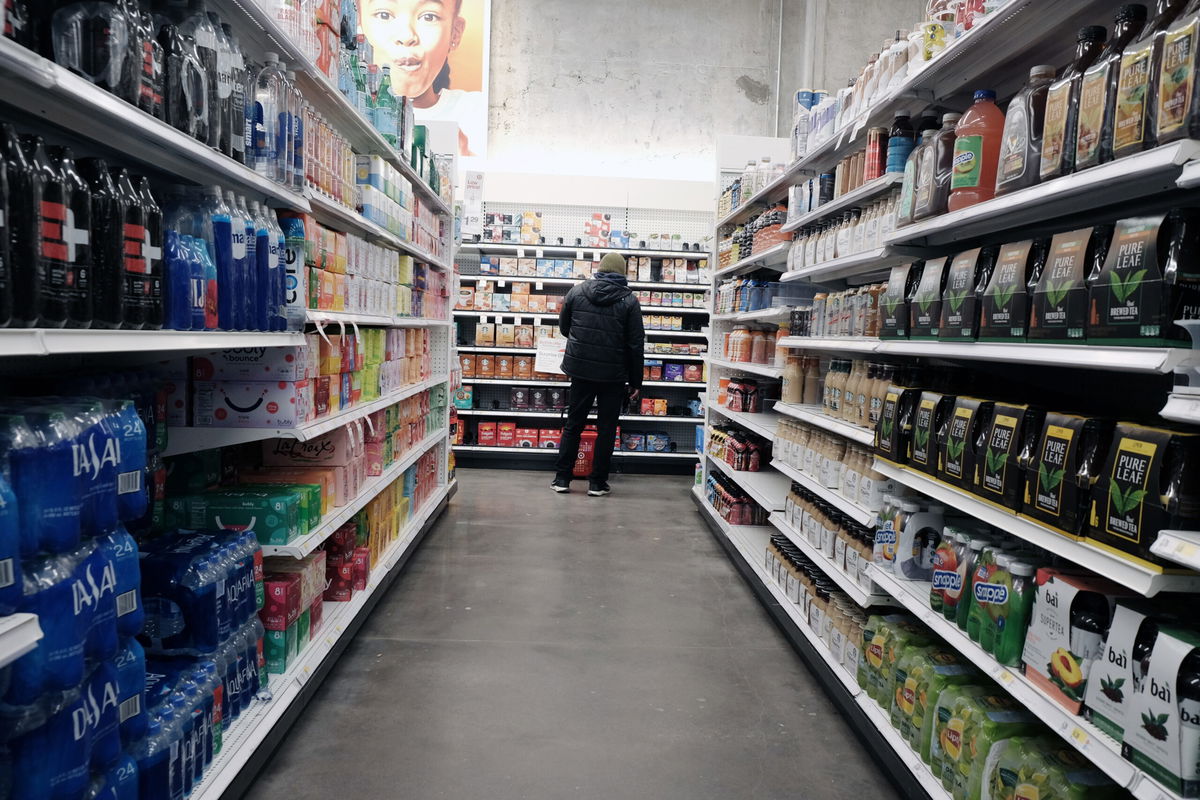 <i>Spencer Platt/Getty Images</i><br/>People shop for groceries in a Manhattan store on January 12 in New York City. America's high prices didn't budge in January. Another key inflation measure showed prices rising last month.