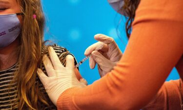 An eight-year-old child receives the Pfizer-BioNTech Covid-19 vaccine for 5 to 11-year-old kids in Hartford