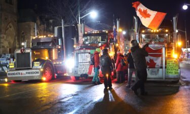 Trucks and protestors block downtown streets near the Parliament Buildings as a demonstration led by truck drivers protesting vaccine mandates continue on February 15 in Ottawa