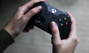 A person uses a Microsoft's Xbox One video game controller in Denver