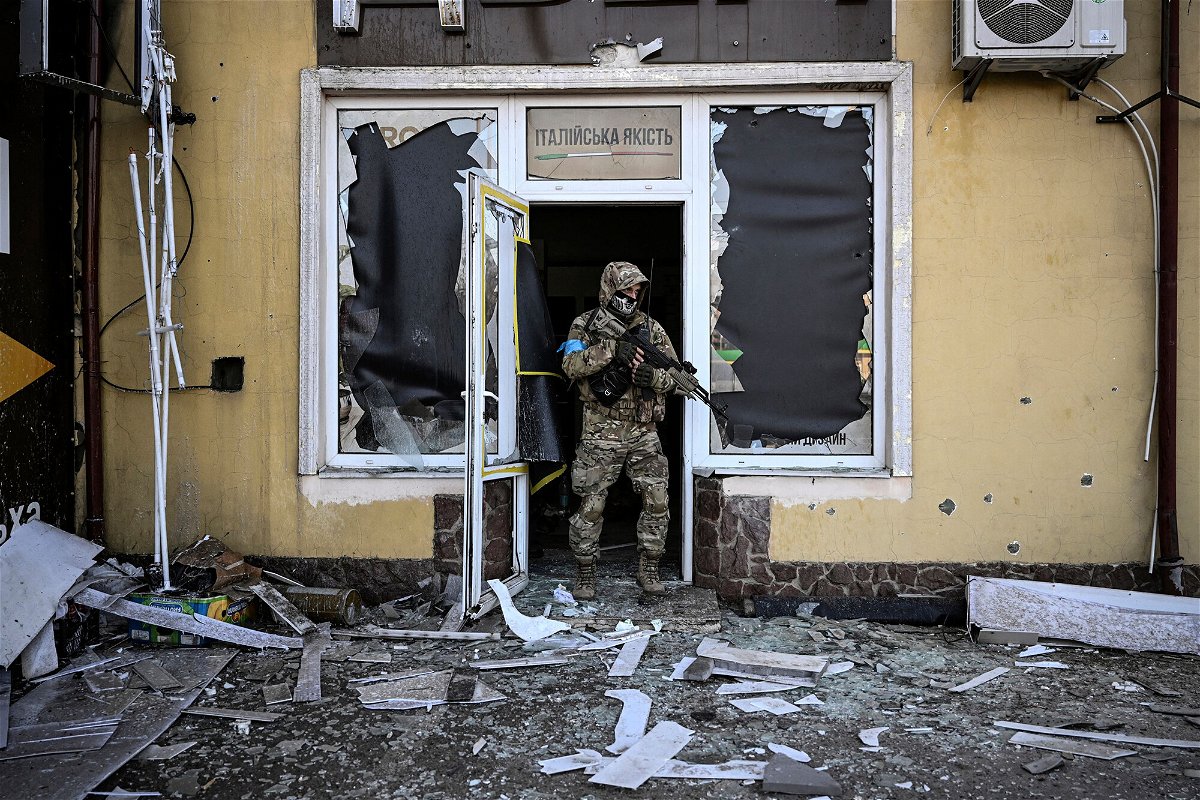 <i>Aris Messinis/AFP/Getty Images</i><br/>A Ukrainian serviceman exits a damaged building after shelling in Kyiv