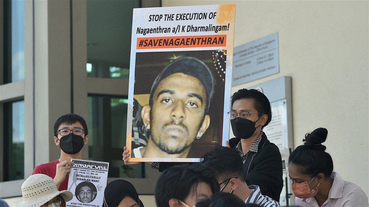 <i>ARIF KARTONO/AFP/Getty Images</i><br/>Activists hold posters displaying messages against the execution of Nagaenthran K. Dharmalingam