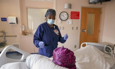 Registered Nurse Mafereh Sesay speaks with a patient at Luminis Health Doctors Community Medical Center on March 16 in Lanham