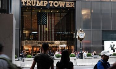 People walk by Trump Tower on September 26