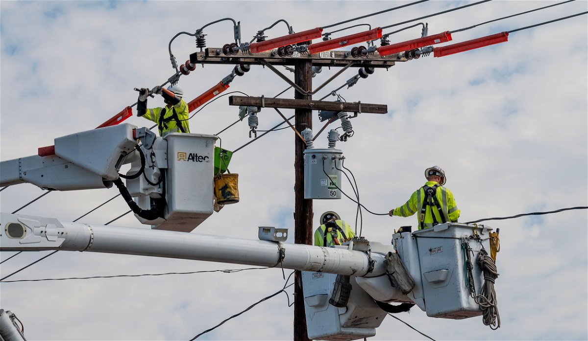 <i>Paul Bersebach/MediaNews Group/Orange County Register/Getty Images</i><br/>Workers with Southern California Edison replace a transformer in 2021. Crews were doing repairs after lightening storms had moved through the area the previous night.
