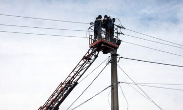 Communal workers repair power lines in Hostomel