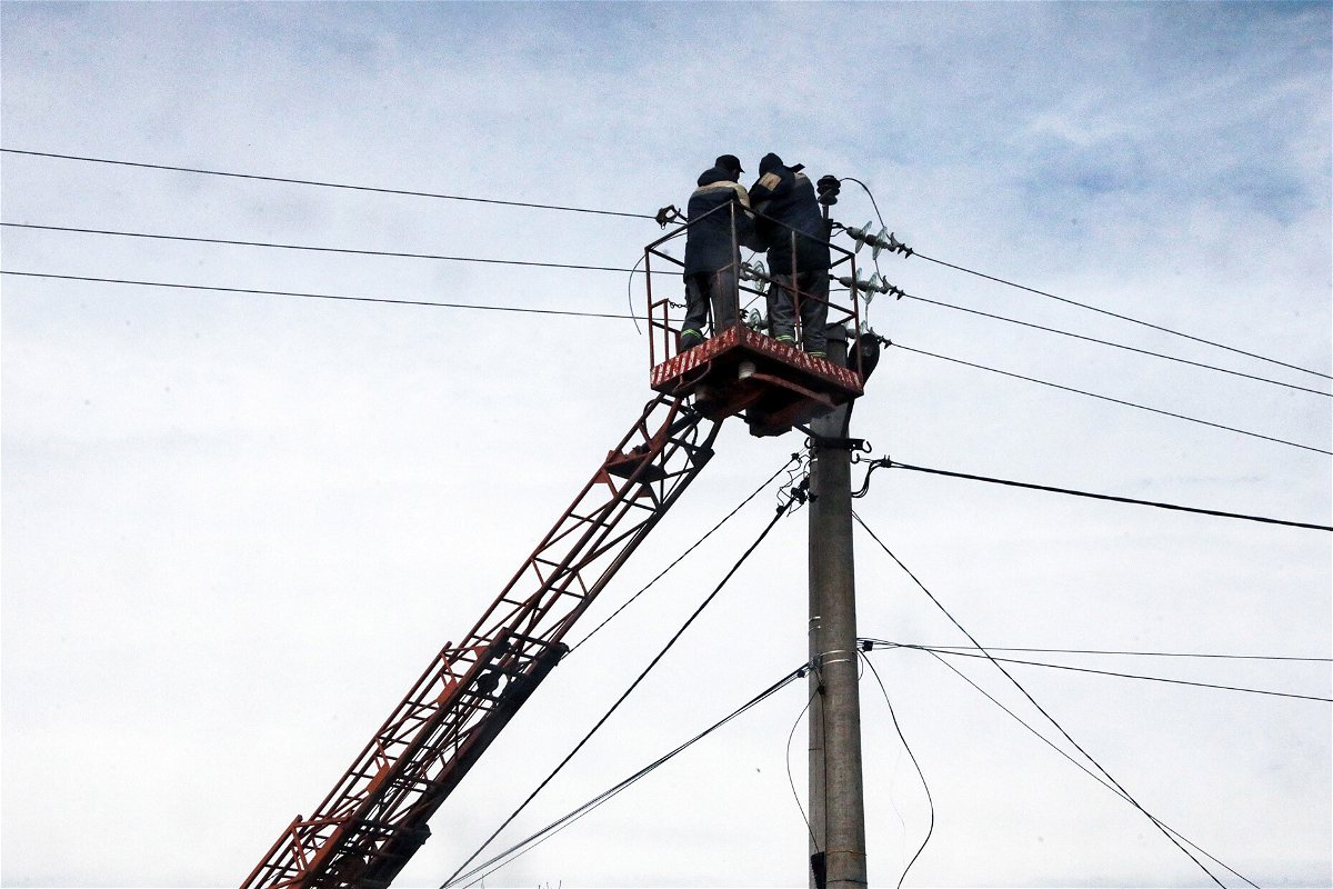 <i>Hennadii Minchenko/Ukrinform/NurPhoto/Getty Images</i><br/>Communal workers repair power lines in Hostomel