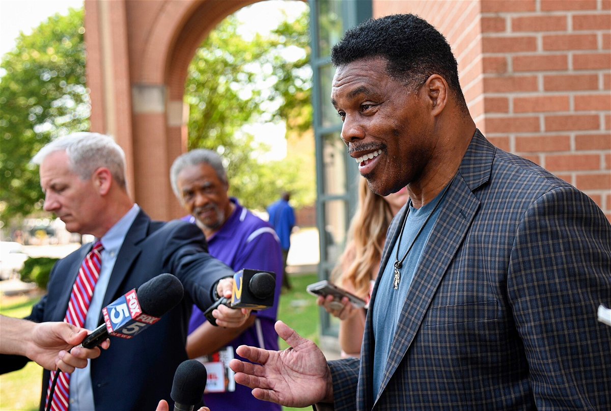 <i>Jason Vorhees/AP</i><br/>Republican Senate candidate Herschel Walker speaks with reporters after a campaign rally at the Georgia Sports Hall of Fame in Macon on May 18.
