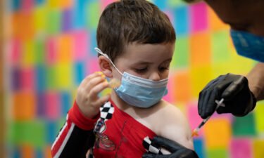 A 3-year-old receives the Moderna coronavirus disease vaccine at Skippack Pharmacy in Schwenksville
