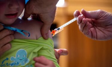 A three-year-old receives the Covid-19 vaccination in Needham
